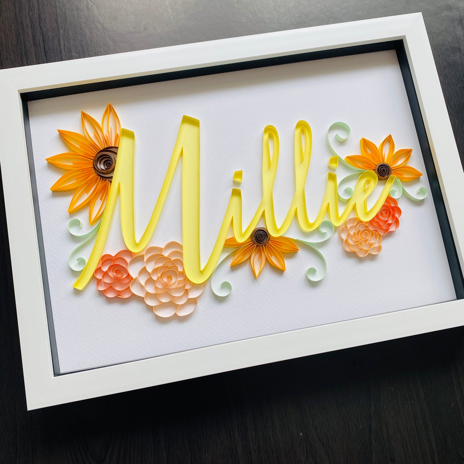 Yellow Quilled name Millie surrounded by sunflowers and roses 